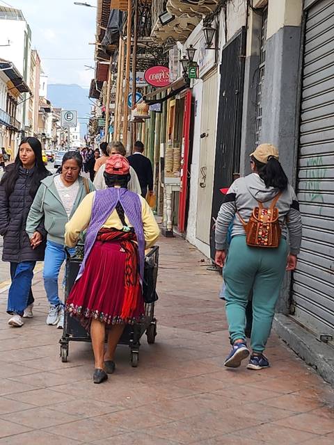 People walking in a street market with traditional clothing.