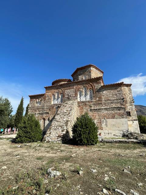 Historic stone building with decorative arches.