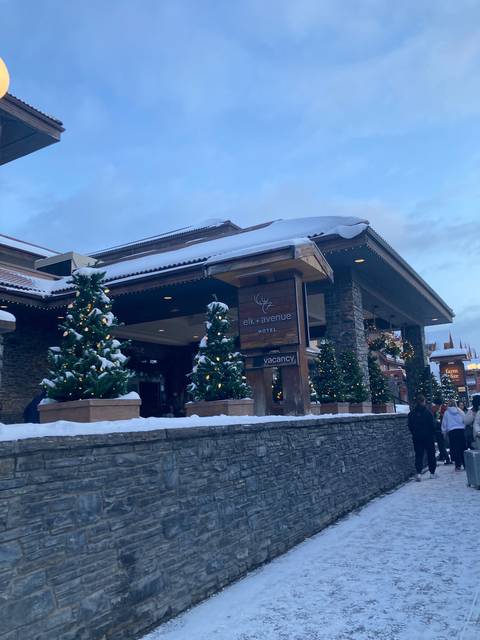       Chalet-style building with festive decorations in a snowy landscape.
  