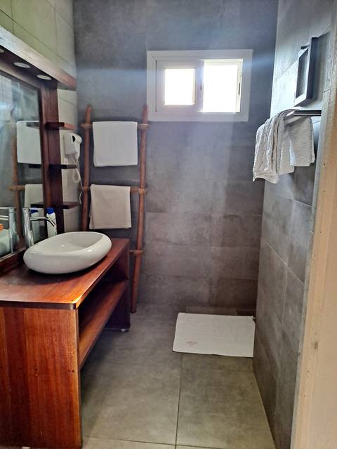       Bathroom with towels on a rack and a window.
  