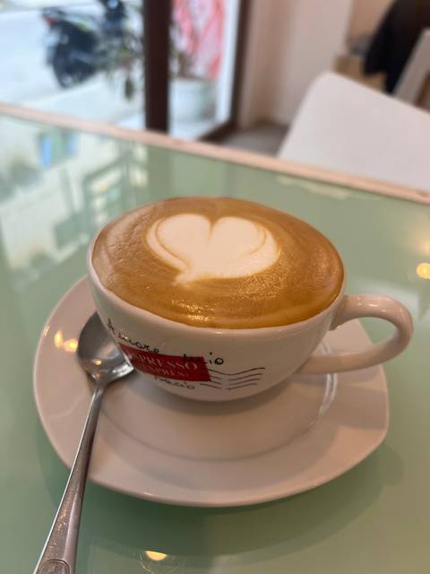       Close-up of a cup of coffee with a heart design.
  