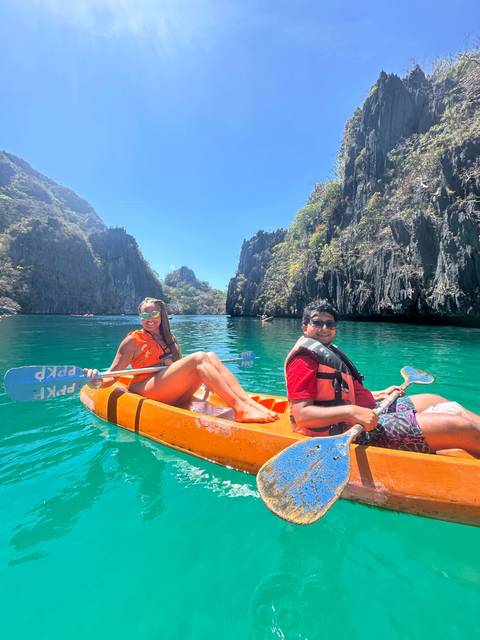       Two people enjoying a kayak ride on turquoise waters.
  