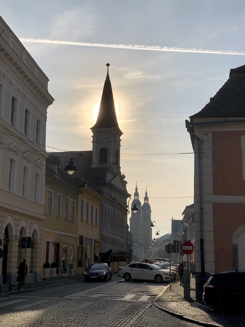 Silhouette of a church tower during sunset with skyline.