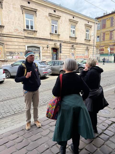       People conversing on a city street.
  