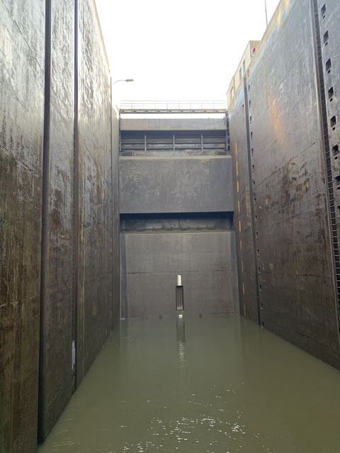 Interior view of a large, concrete structure, possibly a lock.
