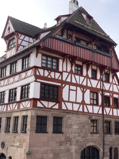 Traditional timber-framed house with intricate window designs.
