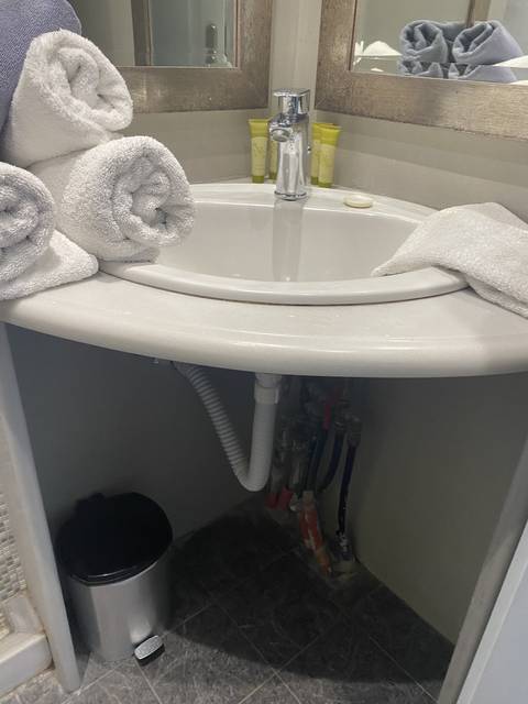Bathroom sink with towels placed beside it.