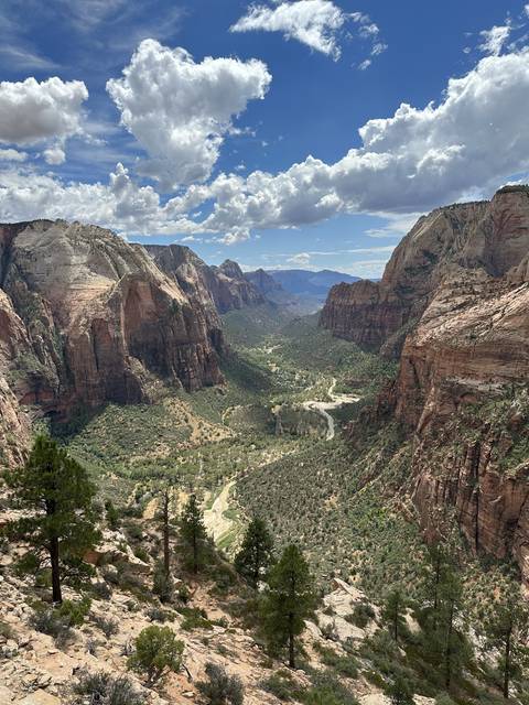       View of a canyon and valley with distinct rock formations.
  