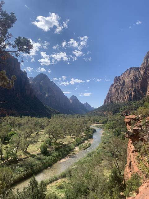       A scenic view of rocky mountains and a river, turned sideways.
  