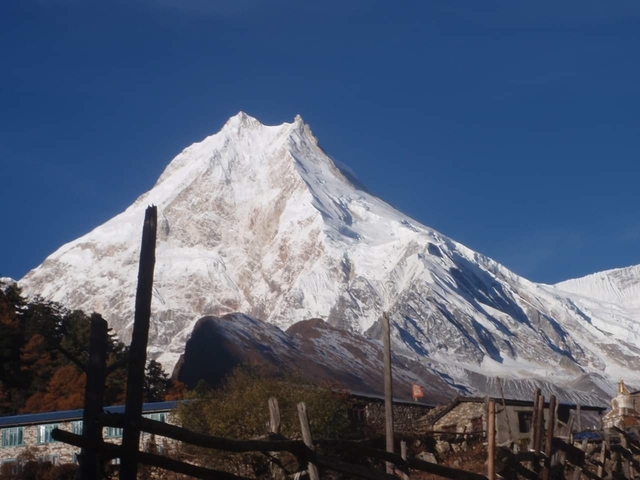 Snow-capped mountain peak under a clear blue sky.