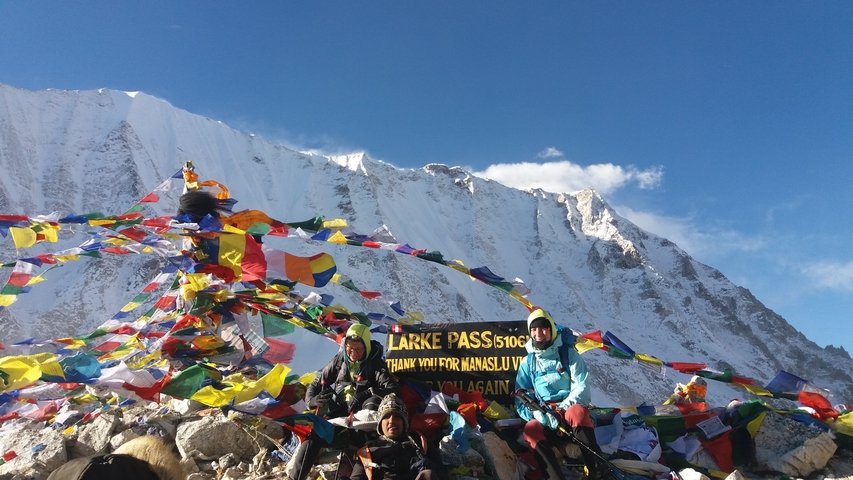 Group of people at Larke Pass with prayer flags.