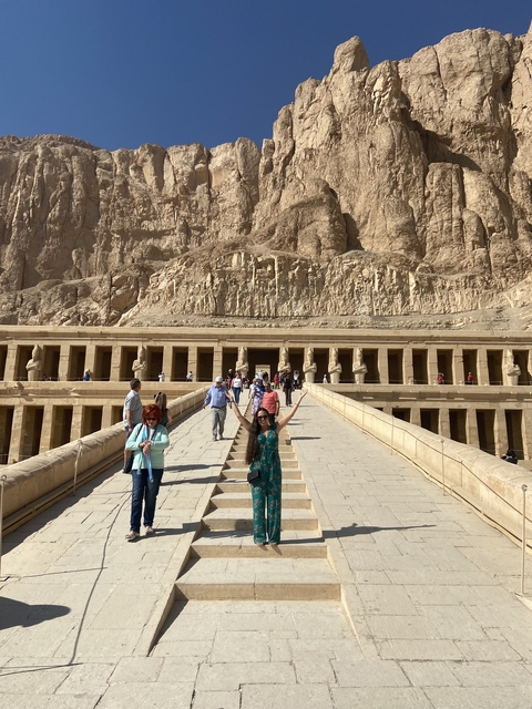 Tourists at an ancient Egyptian temple with pillars.