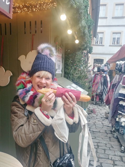 Woman eating a sandwich at a market