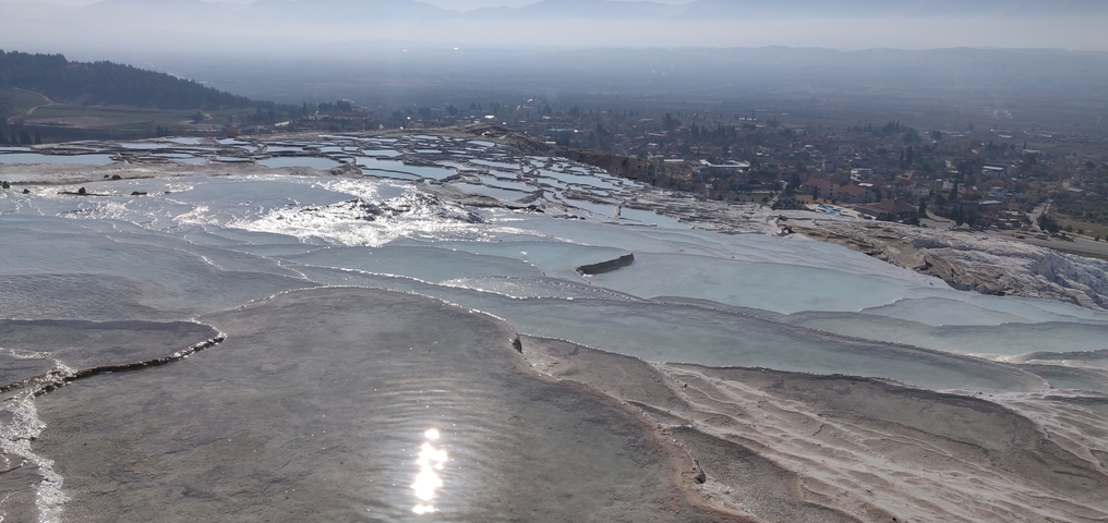 Pamukkale's white travertine terraces with water.