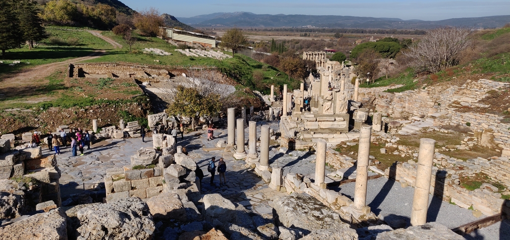       Ancient ruins with columns and statues.
  