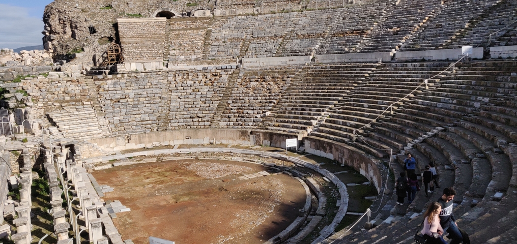      Ancient amphitheater with stone steps.
  