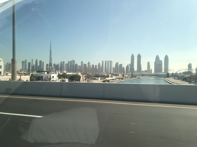       Expansive city skyline with a waterway.
  