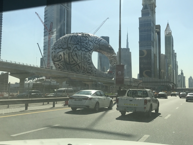       Futuristic building with Arabic script design.
  