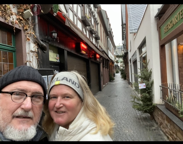 Selfie with two people in a narrow European street.