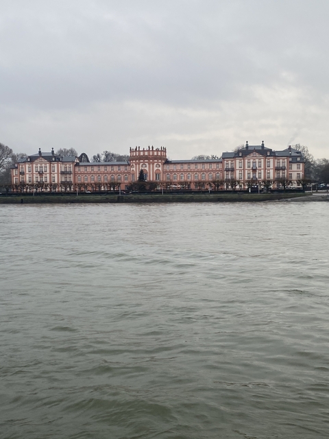 Large building with river in the foreground.