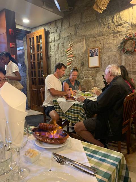 People dining at a restaurant with stone walls.