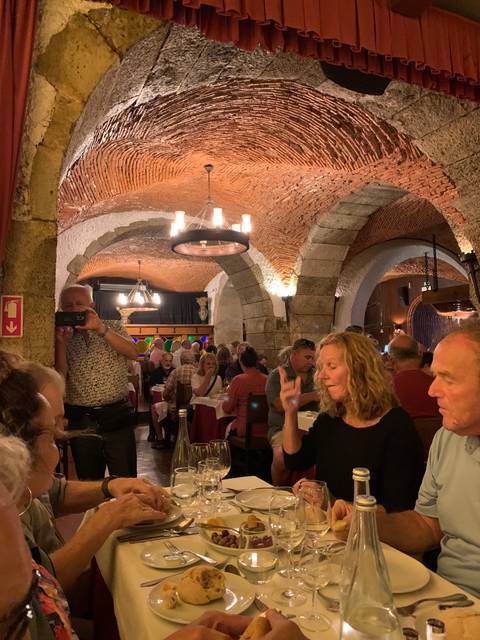       Restaurant interior with diners at tables.
  