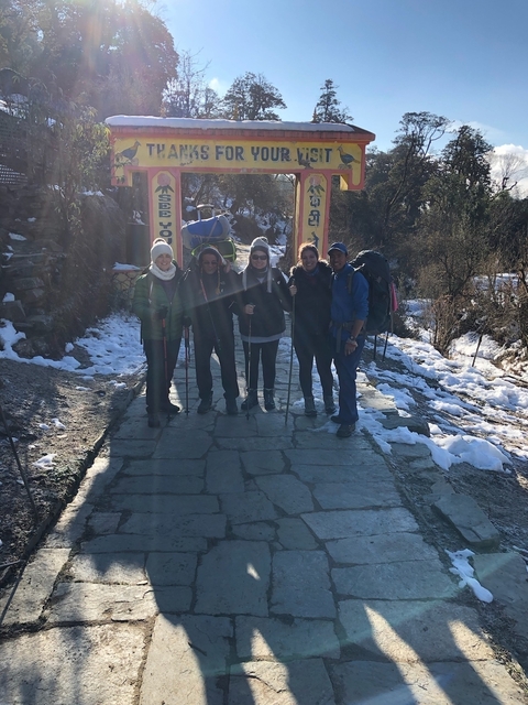 Group of hikers on a snowy path.