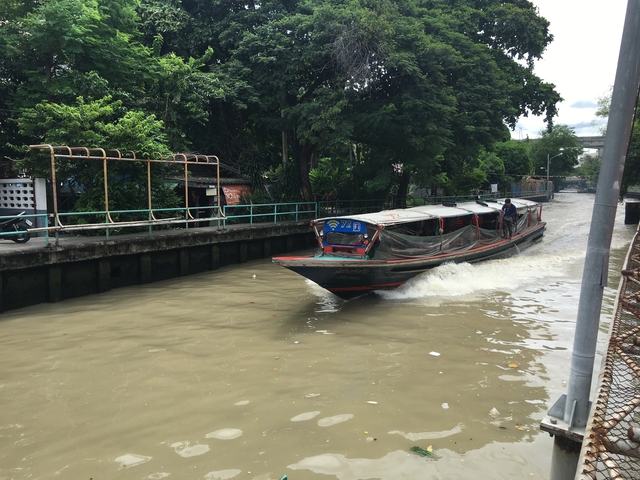 Canal boat moving through a waterway in an urban area
