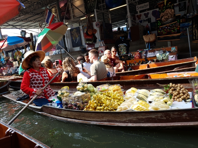 Floating market with various fruits and people in boats