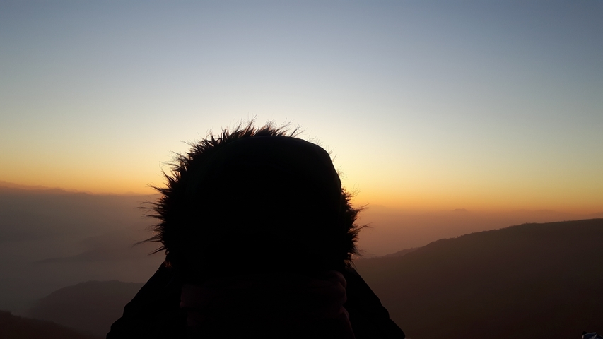 Silhouette of a person against a sunset.