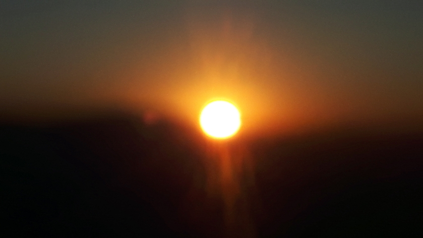 Blurry image of a sunrise.