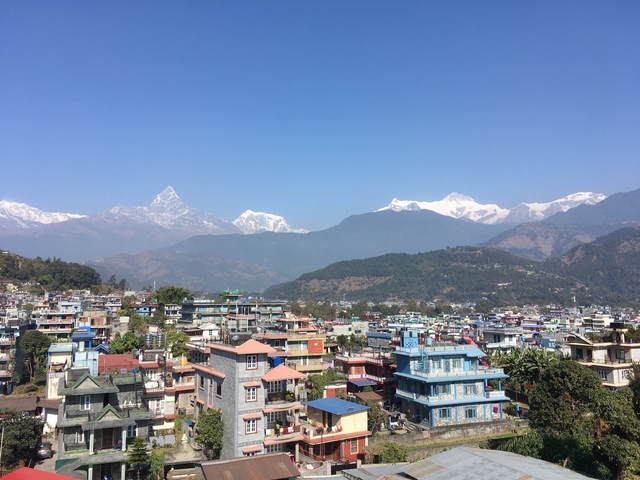 A cityscape with mountains in the background.