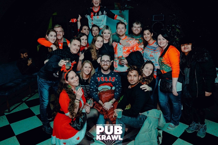 Large group of people in festive attire posing indoors.