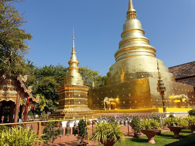 Golden stupa and pagoda in a temple complex.