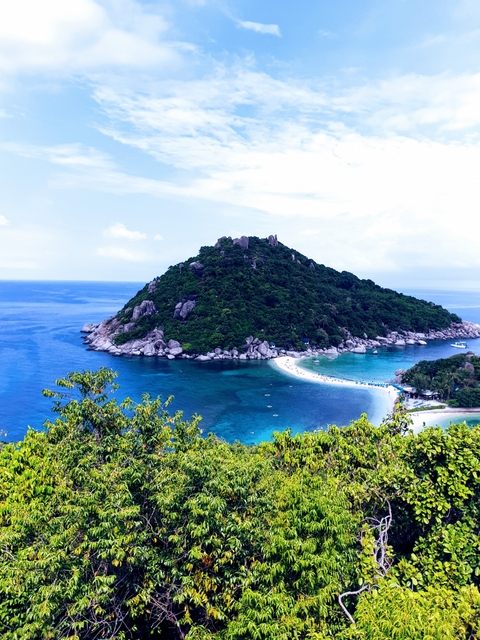 A picturesque island surrounded by clear blue waters.