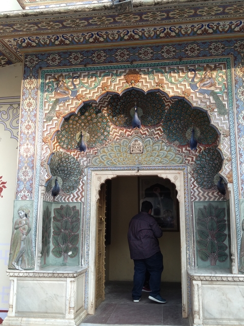 An ornately carved peacock door with intricate details.