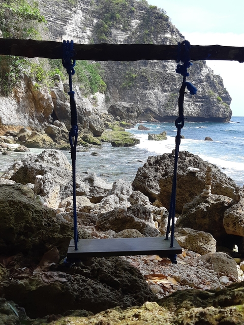       Rocky shore with small waves and stacked rocks.
  