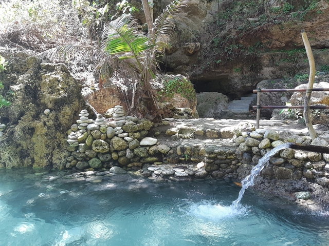       Rocky area with water and a small waterfall.
  