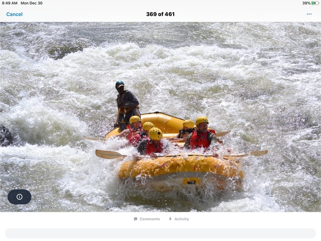 Group of people rafting on a river with crashing waves.