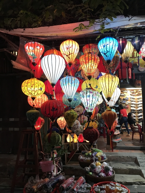       Colorful Vietnamese lanterns hanging inside a shop.
  
