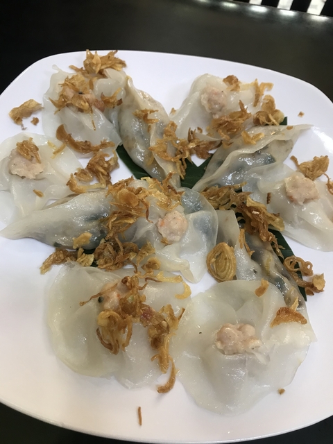       Plate of Vietnamese dumplings with fried onions on top.
  