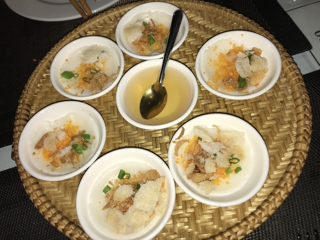       Assorted bowls of Vietnamese appetizers with dipping sauce.
  