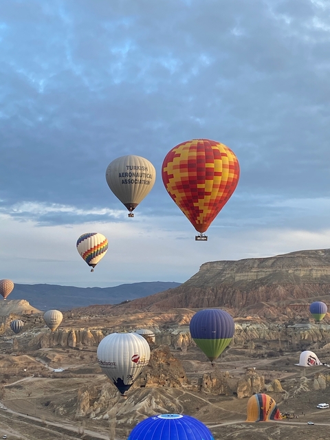       Close-up of three hot air balloons in flight.
  