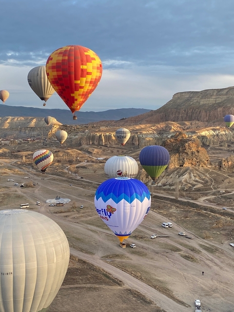       Hot air balloons over a rocky landscape in Cappadocia.
  
