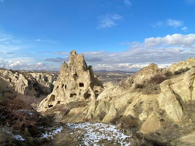       Rock formations with cave dwellings in Cappadocia.
  