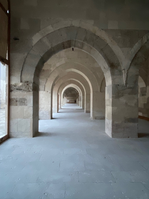       Stone archway with a long corridor.
  