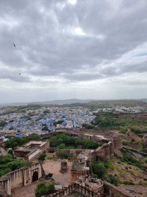       City view with fort and blue painted houses.
  