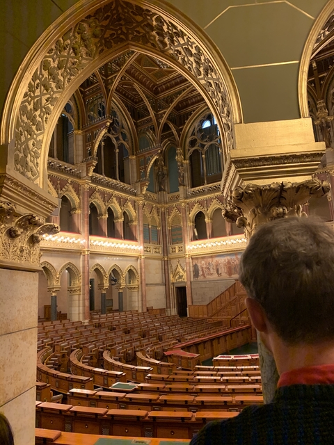 Ornate interior of a classical building with gold accents.