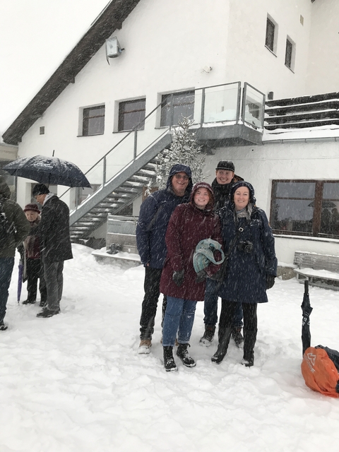       Group of people posing in a snowy scene.
  