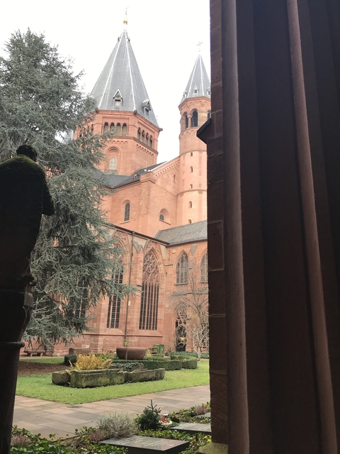       View of a historical church with Gothic architecture from a window.
  